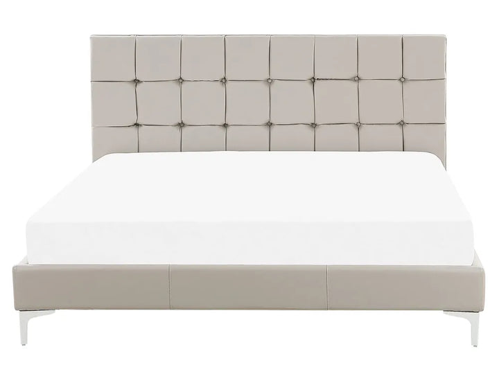 Beige upholstered bed with tufted headboard on a white background