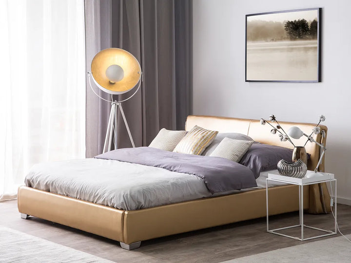Modern bedroom with a beige bed, side table, and lamp.