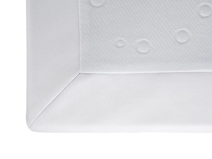 White textured surface with embossed circular patterns