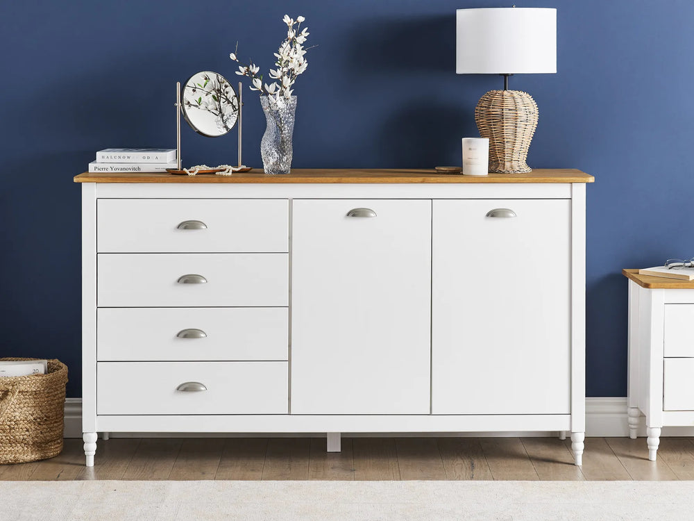 White dresser with wooden top against a blue wall