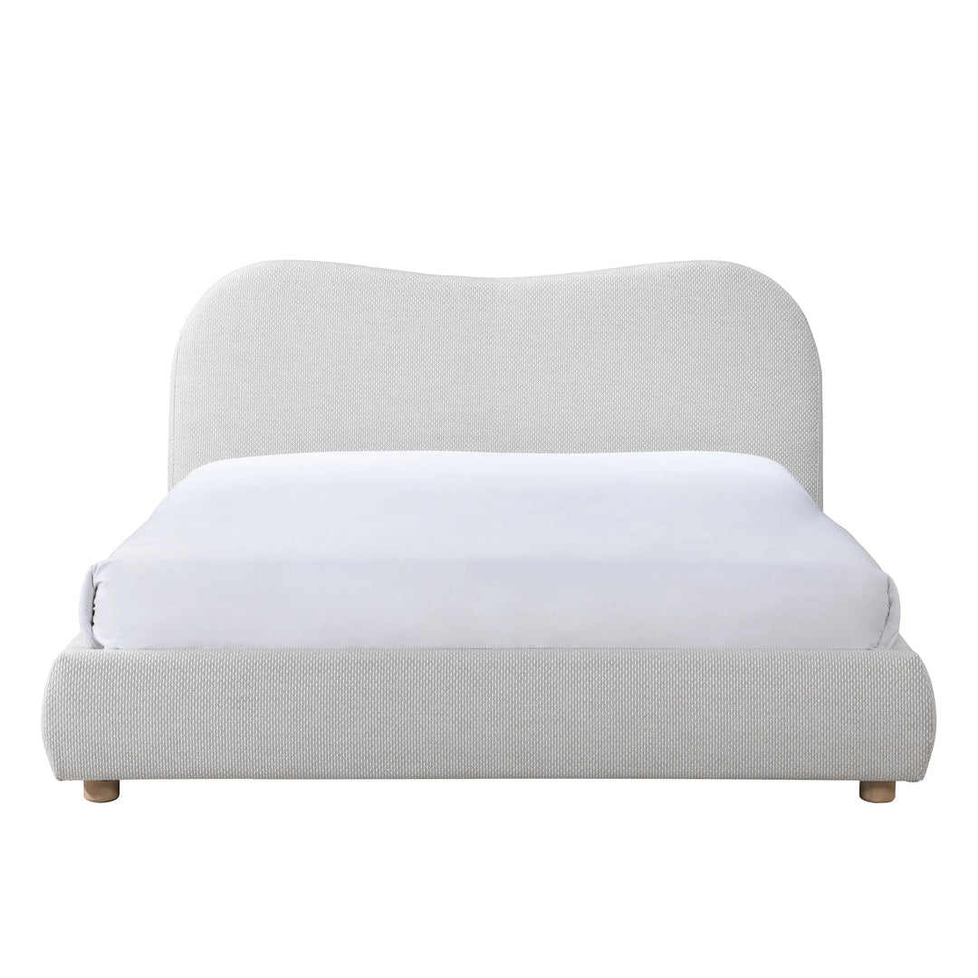 Light gray upholstered bed with a white mattress on a white background