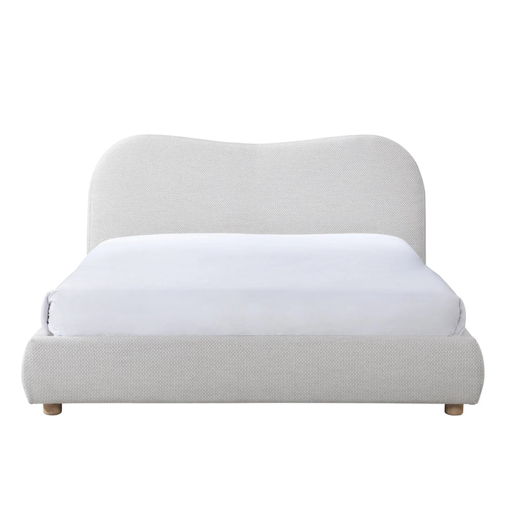 Light gray upholstered bed with a white mattress on a white background