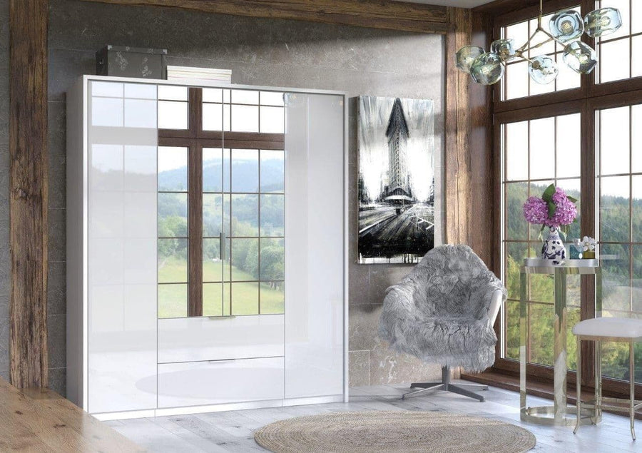 Modern interior design with a gray armchair, large windows, and decorative elements.