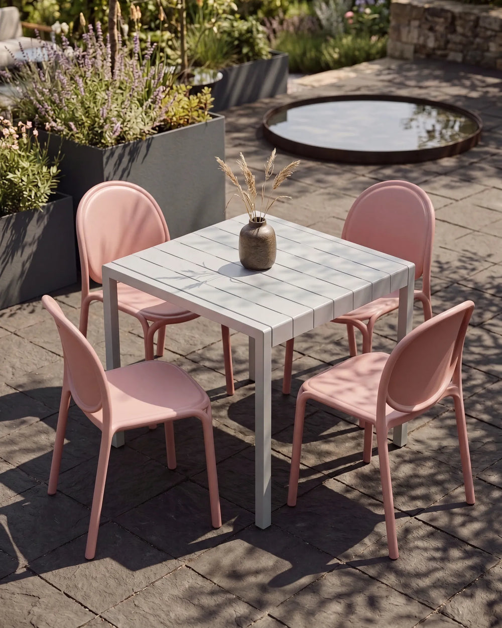 Four pink stackable garden dining chairs