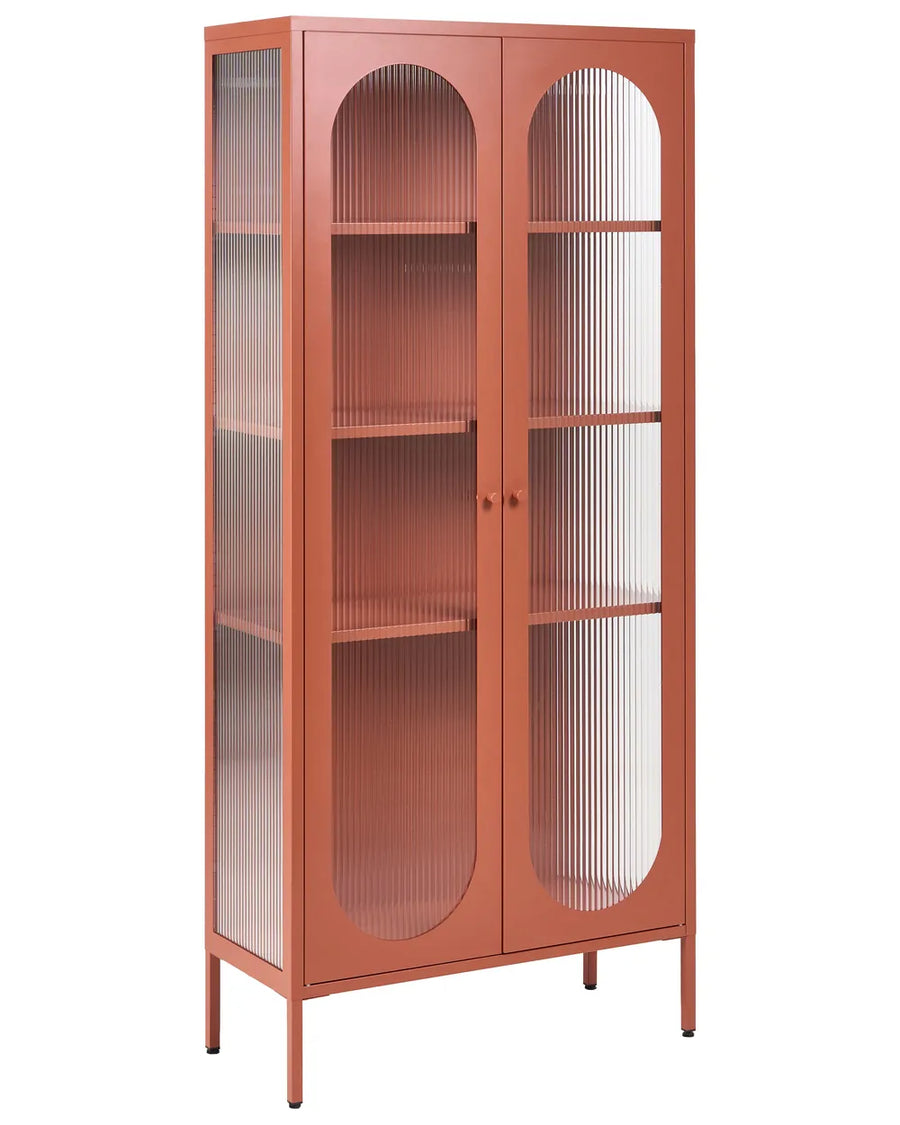 A tall, narrow display cabinet with a terracotta orange finish and two arched glass doors with vertical fluted panels, shown on a plain white background.