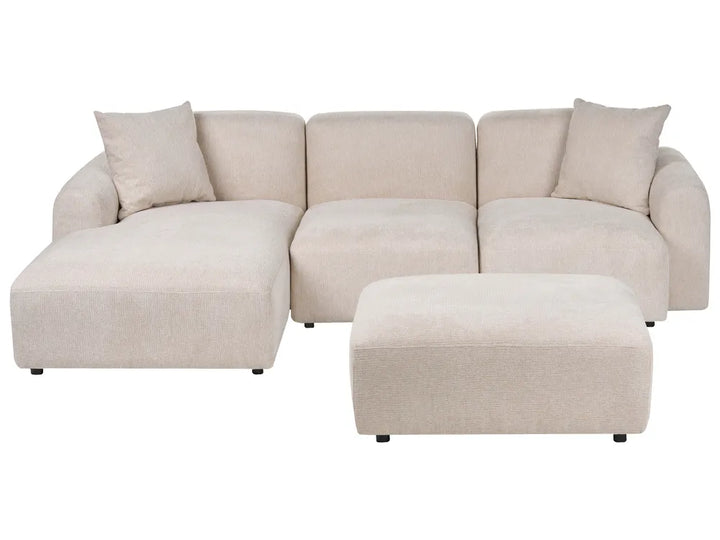 A light beige fabric sectional sofa with a chaise lounge on the left and a matching rectangular ottoman, shown against a plain white background.