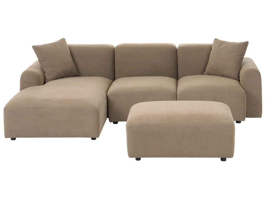 A modern beige fabric sectional sofa with a left-facing chaise lounge and two matching throw pillows, paired with a matching rectangular ottoman, shown against a plain white background.