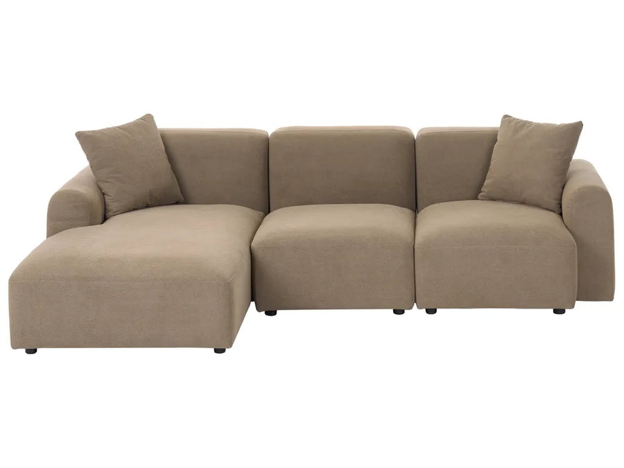 A modern three-seater sectional sofa with a left-facing chaise lounge, upholstered in a textured taupe fabric, featuring two matching throw pillows, shown against a plain white background.