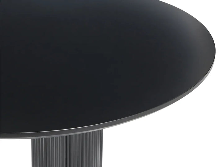 Close-up of a round black table top with a ribbed pedestal base on a white background.