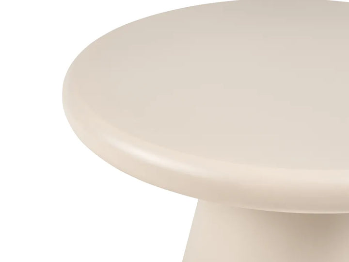Close-up of a minimalist round pedestal table with a smooth, matte off-white finish on a solid white background.