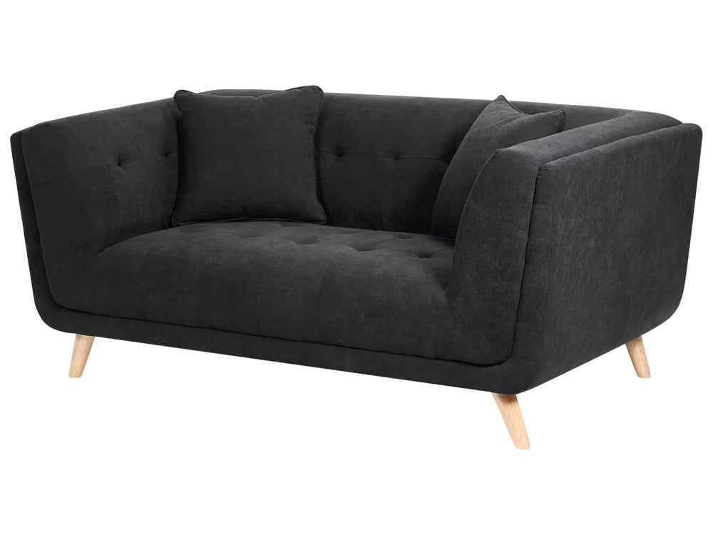 A modern two-seater sofa in dark charcoal gray fabric with tufted button details on the backrest and seat, supported by light natural wood legs, shown against a plain white background.