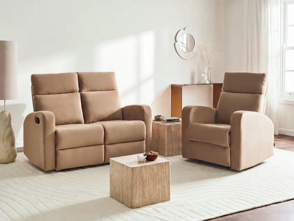 A beige upholstered reclining loveseat and matching reclining armchair set in a bright, modern living room with a light wood coffee table and side table.