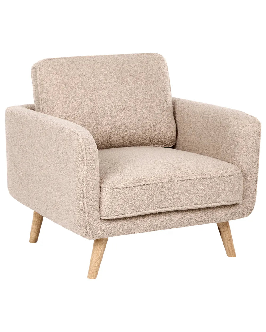 A single upholstered armchair with a textured bouclé fabric in a warm beige color, featuring light natural wood legs, shown against a plain white background.