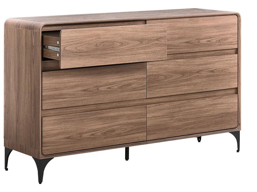A modern wooden dresser with a warm medium-brown wood grain finish, featuring six drawers (one partially open to show the drawer pull), tapered black metal legs, and a curved front detail on the top surface, shown against a plain white background.