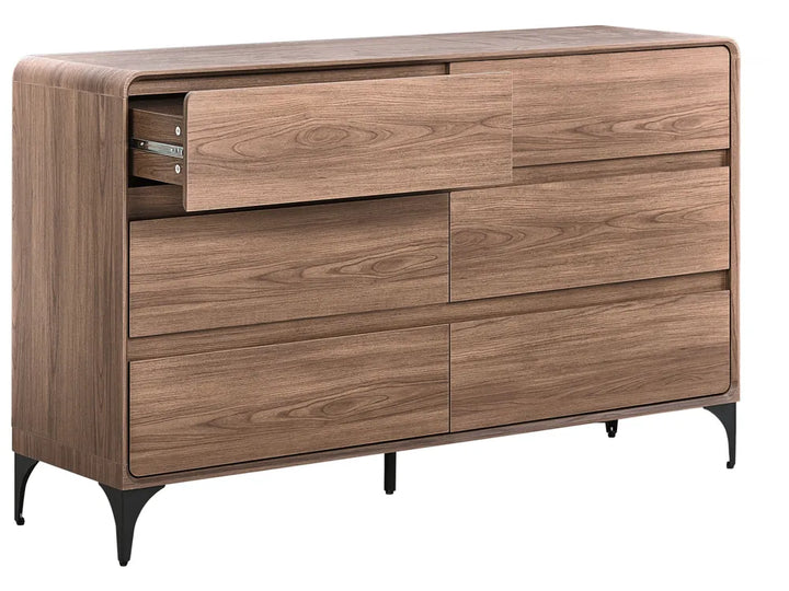 A modern wooden dresser with a warm medium-brown wood grain finish, featuring six drawers (one partially open to show the drawer pull), tapered black metal legs, and a curved front detail on the top surface, shown against a plain white background.