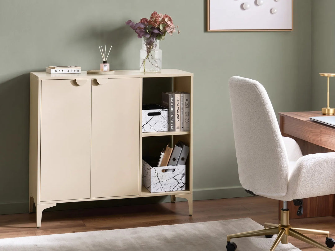 Beige storage cabinet with books and decorative items in a room with a green wall and a desk.