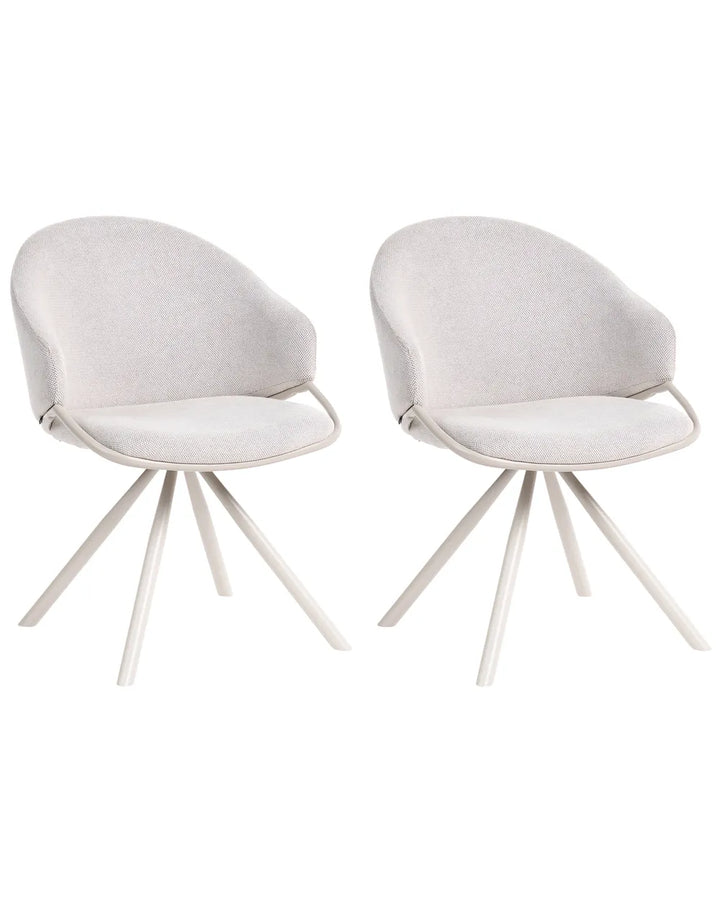 Two modern dining chairs with light beige textured fabric upholstery and white metal tripod legs, shown side-by-side on a white background.