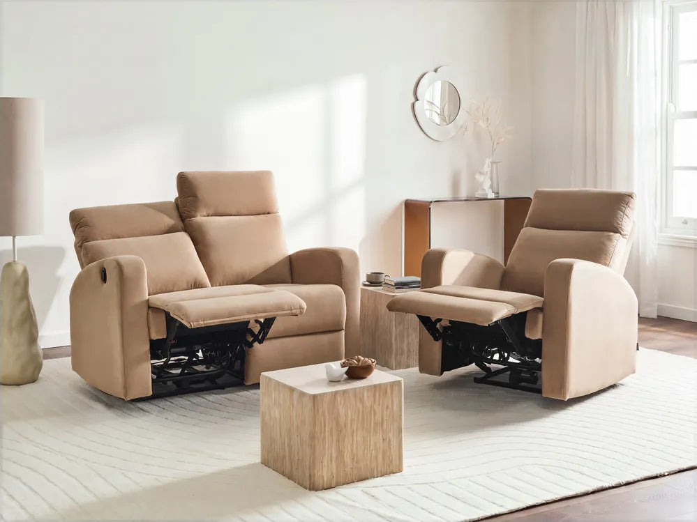 A beige upholstered recliner sofa and matching armchair with extended footrests, shown in a bright, modern living room with a small wooden side table and rug.