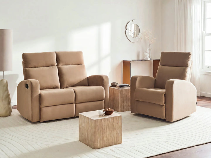 A beige upholstered reclining loveseat and matching reclining armchair set in a bright, modern living room with a light wood coffee table and side table.