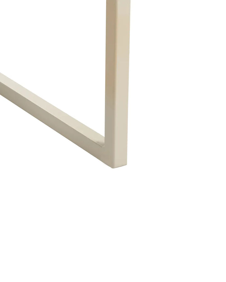 Close-up of a light beige or cream-colored metal frame corner, showing the edge and joint detail against a solid white background.