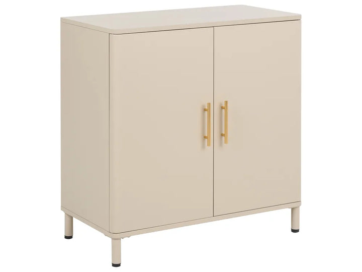 A modern two-door cabinet in a warm cream or beige finish, featuring slim gold handles and short legs with black tips, shown against a plain white background.