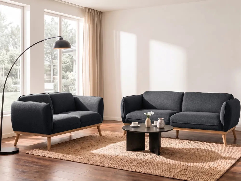 Modern living room with dark gray sofa set and floor lamp.