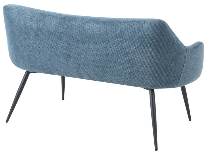 A modern upholstered bench with a curved backrest in textured blue fabric and slim black metal legs, shown against a plain white background.