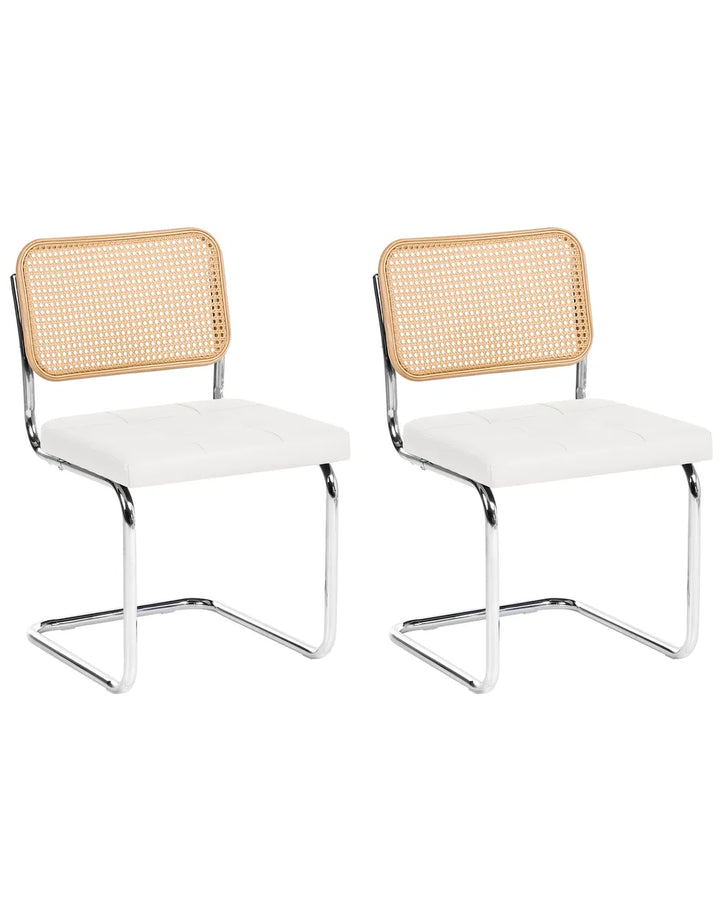 Two matching modern dining chairs with white upholstered seats, natural woven cane backrests, and chrome cantilevered metal bases, shown on a plain white background.