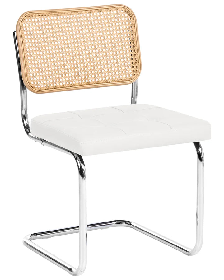 A modern side chair with a white tufted seat cushion, a natural woven cane backrest, and a chrome cantilever metal frame, shown on a solid white background.