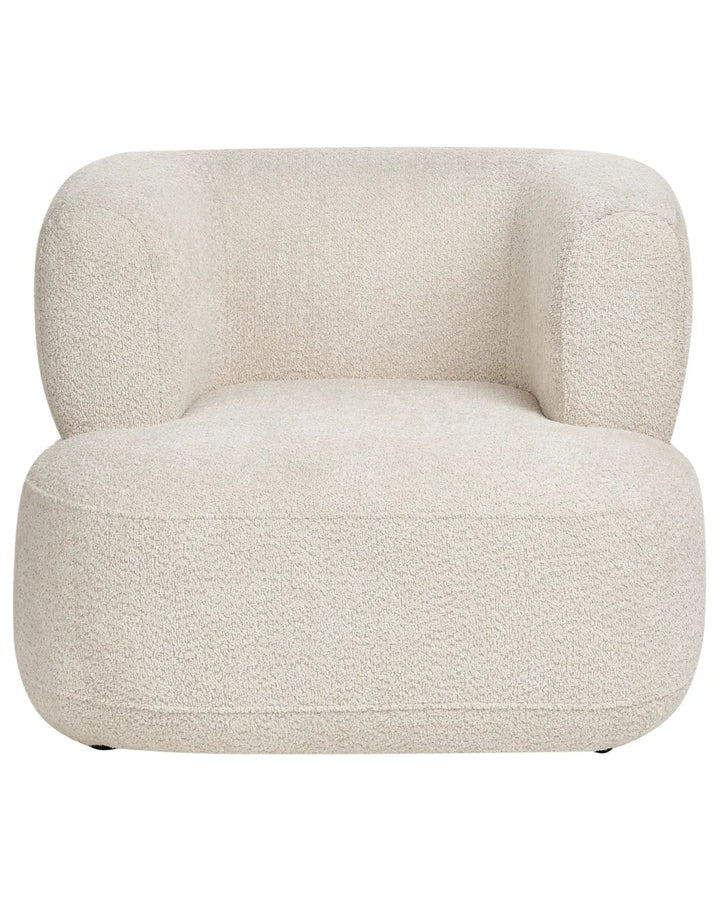 A modern low-profile armchair upholstered in a textured bouclé fabric in a warm off-white or cream color, shown against a plain white background.