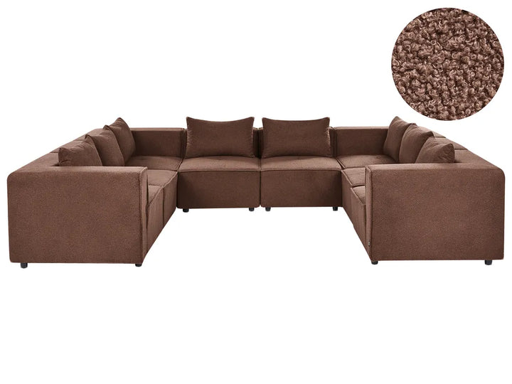 A brown fabric sectional sofa with matching back cushions, shown on a plain white background with a circular close-up inset of the carpet/fabric texture in the upper right.