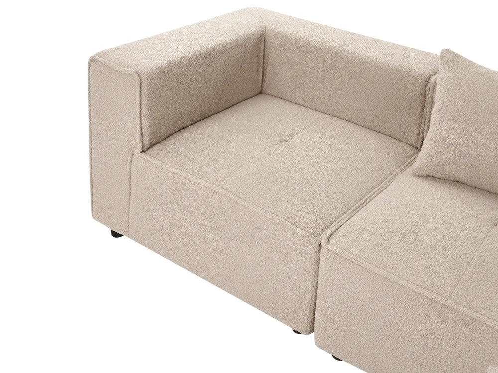 Beige textured fabric modular sofa section with a tufted seat cushion and matching back cushion, shown on a white background.