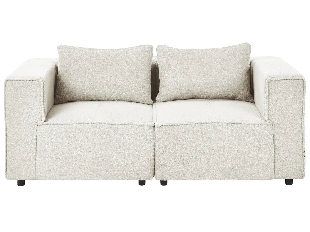 A modern two-seater sofa in a textured cream bouclé fabric, featuring two matching square back cushions and small black feet, shown against a plain white background.