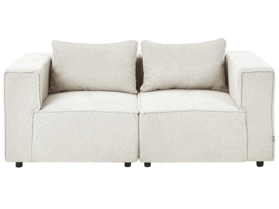 A modern two-seater sofa in a textured cream bouclé fabric, featuring two matching square back cushions and small black feet, shown against a plain white background.