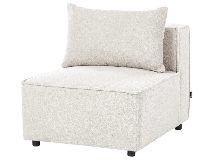 A modern low-profile accent chair upholstered in a textured cream bouclé fabric, featuring a matching square throw pillow and small black feet, shown against a plain white background.