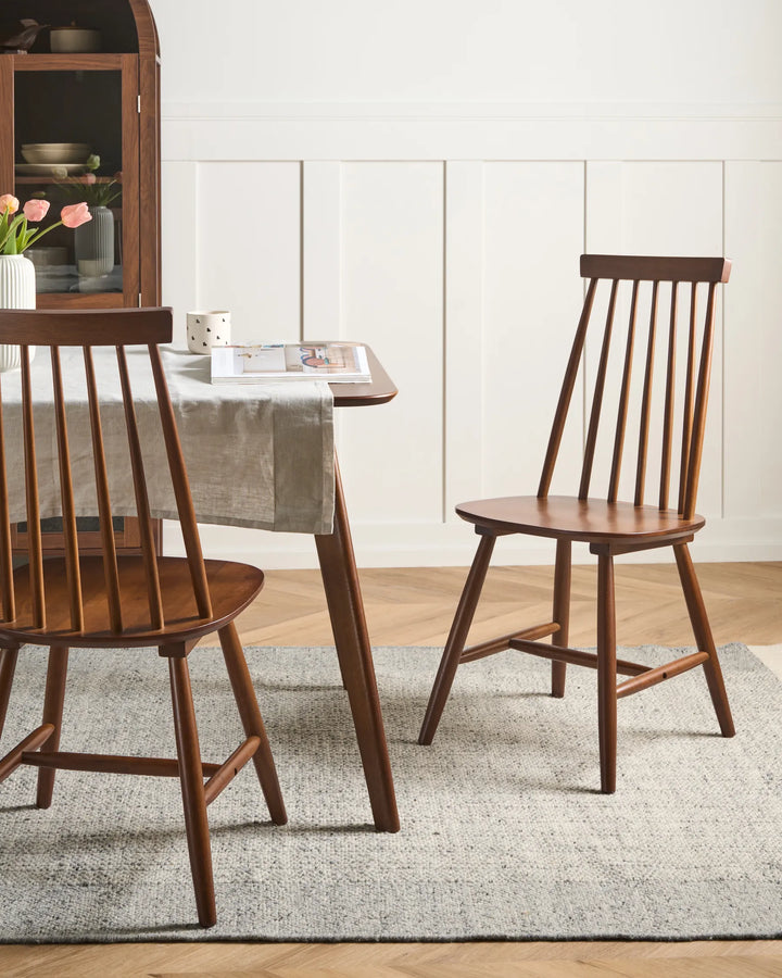 Dining room with wooden table and chairs on a gray rug