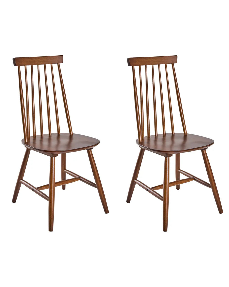 Two wooden dining chairs with spindle backs and angled legs, shown side by side on a plain white background.