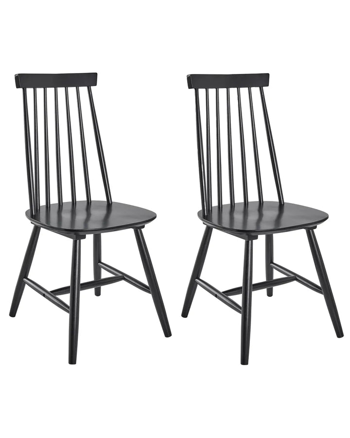 Two black wooden dining chairs with spindle backs and angled legs, shown side by side on a plain white background.