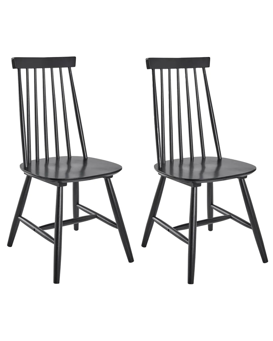 Two black wooden dining chairs with spindle backs and angled legs, shown side by side on a plain white background.