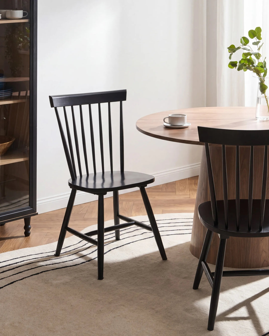 Dining room with black chairs and a wooden table.