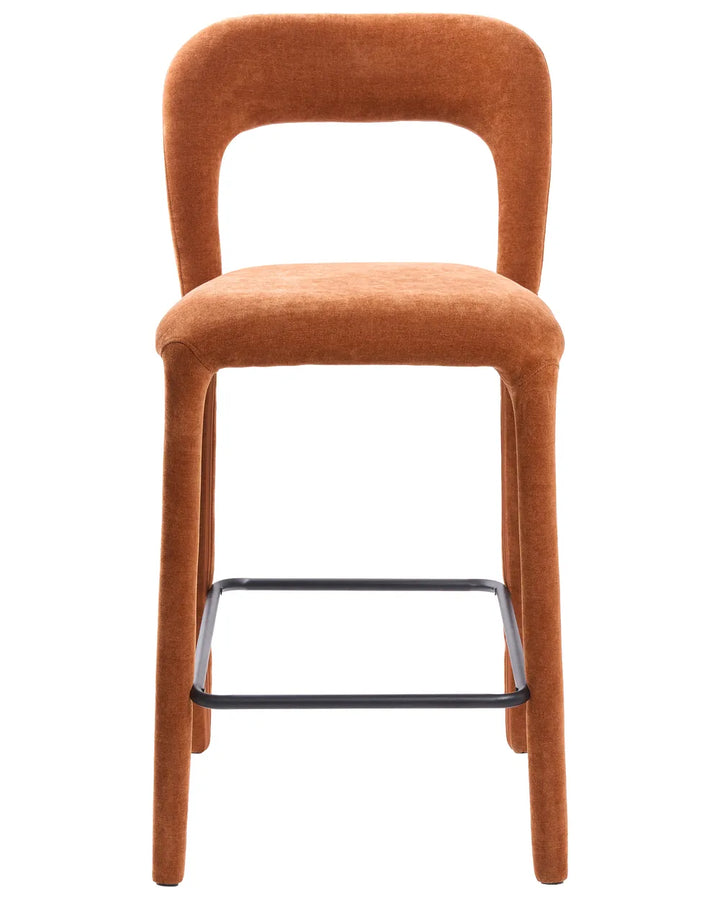 An upholstered bar stool with a rounded backrest, cushioned seat, and slim black metal footrest, shown against a plain white background.