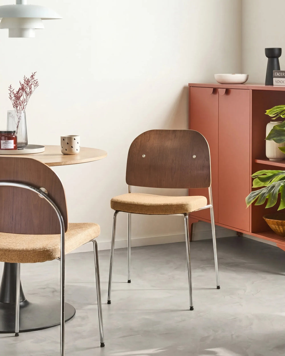 Dining chairs with wooden seats and metal frames in a modern kitchen setting.