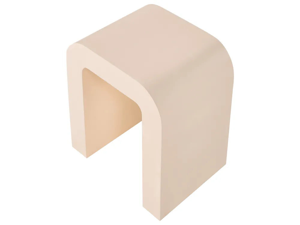 A minimalist U-shaped side table or stool in a warm beige finish, shown from an elevated perspective against a solid white background.