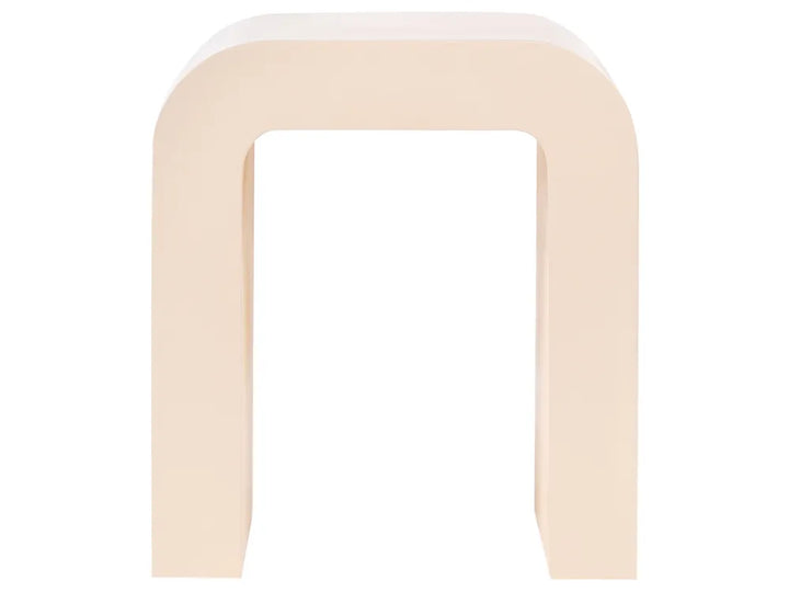A minimalist U-shaped stool in a solid cream color, photographed from a direct front angle against a seamless white background.