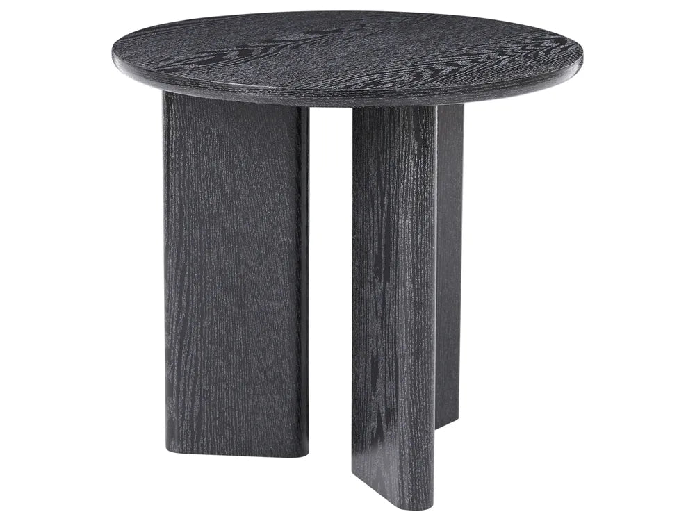A round side table with a dark charcoal gray wood grain finish, featuring three blocky legs, shown against a plain white background.