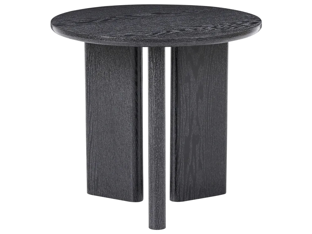 A round side table with a dark charcoal gray wood grain finish, featuring a thick circular top and three blocky, tapered legs, shown against a plain white background.