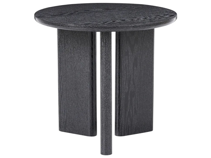 A round side table with a dark charcoal gray wood grain finish, featuring a thick circular top and three blocky, tapered legs, shown against a plain white background.