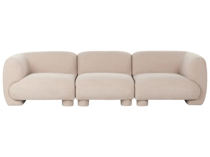 A modern three-seater sofa upholstered in a light beige textured fabric, featuring rounded blocky arms and cylindrical legs, shown against a plain white background.