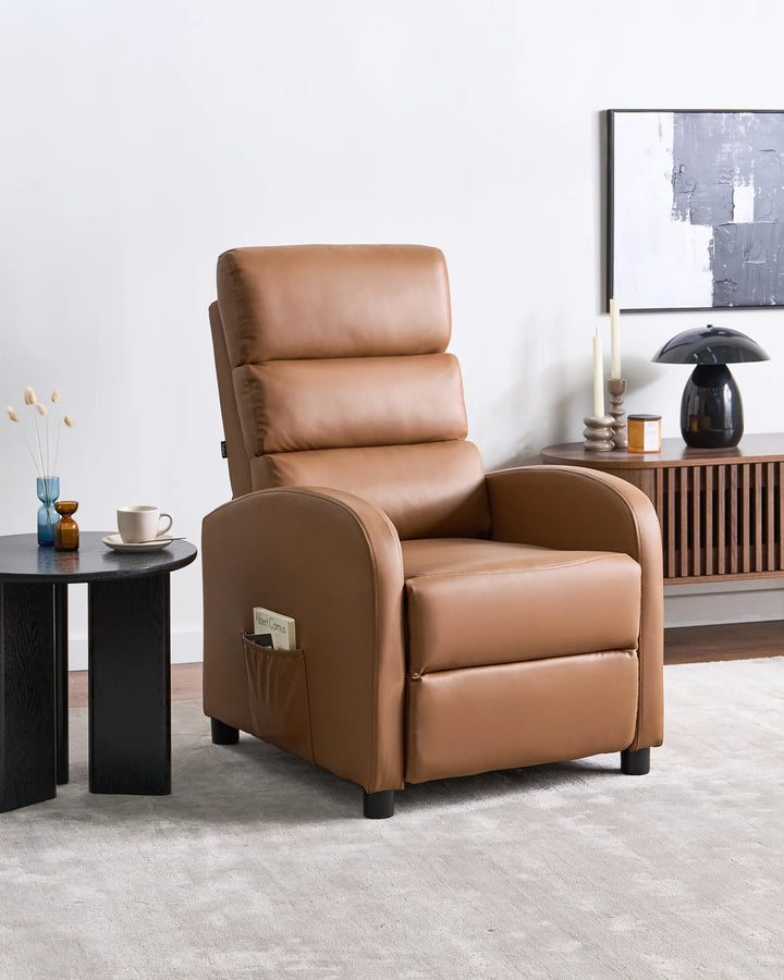 Brown leather recliner chair in a living room setting with a side table and decor items.