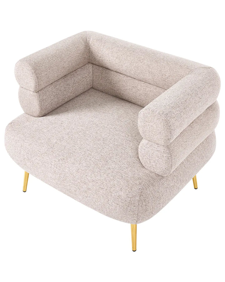A modern low-profile accent chair upholstered in a textured light beige fabric, featuring stacked cylindrical armrests and slim gold metal legs, shown on a solid white background.